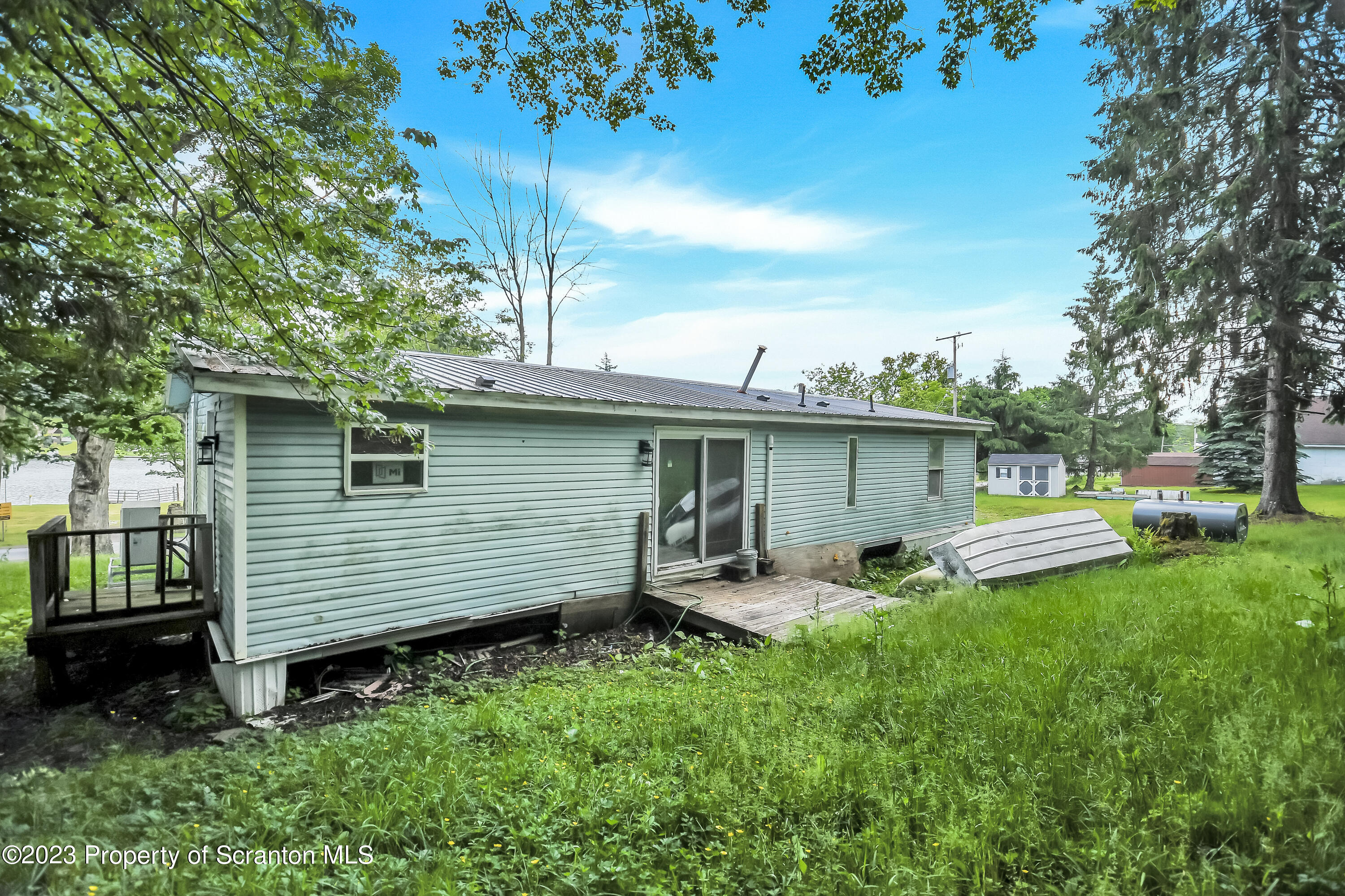 11715 Forest Lake Road Montrose, PA 18801 - Photo 40 of 40 a view of a chair and table in back yard of the house