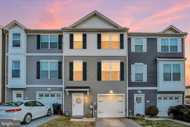 a front view of a residential apartment building with a yard