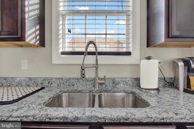 a kitchen with granite countertop a sink and a window