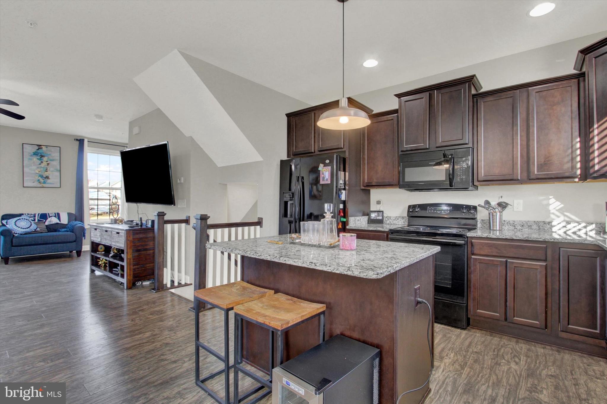 30 Brookside Avenue Hanover, PA 17331 - Photo 12 of 23 a kitchen with cabinets a counter and chairs in it