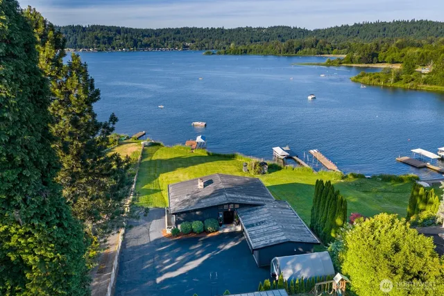 an aerial view of a house with a lake view