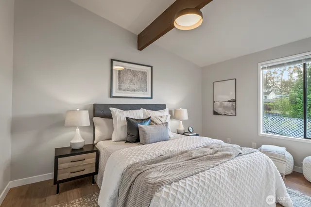 a bedroom with a bed and a window