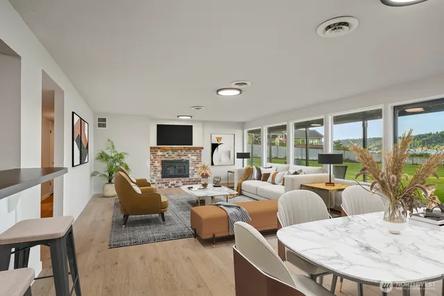a living room with furniture large window and a flat screen tv