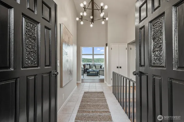 a view of a hallway with a door and stairs