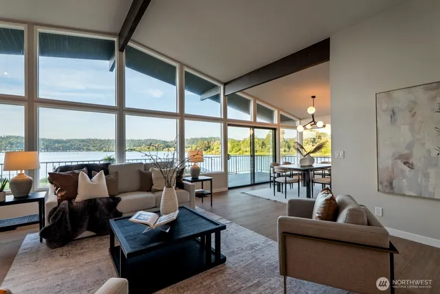 a living room with furniture and floor to ceiling windows