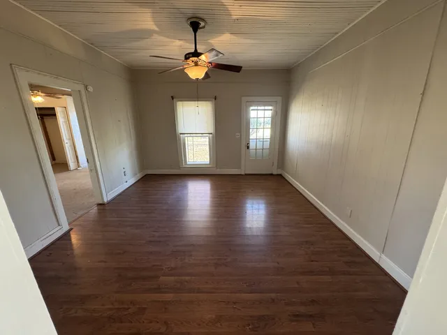 wooden floor in an empty room with a window