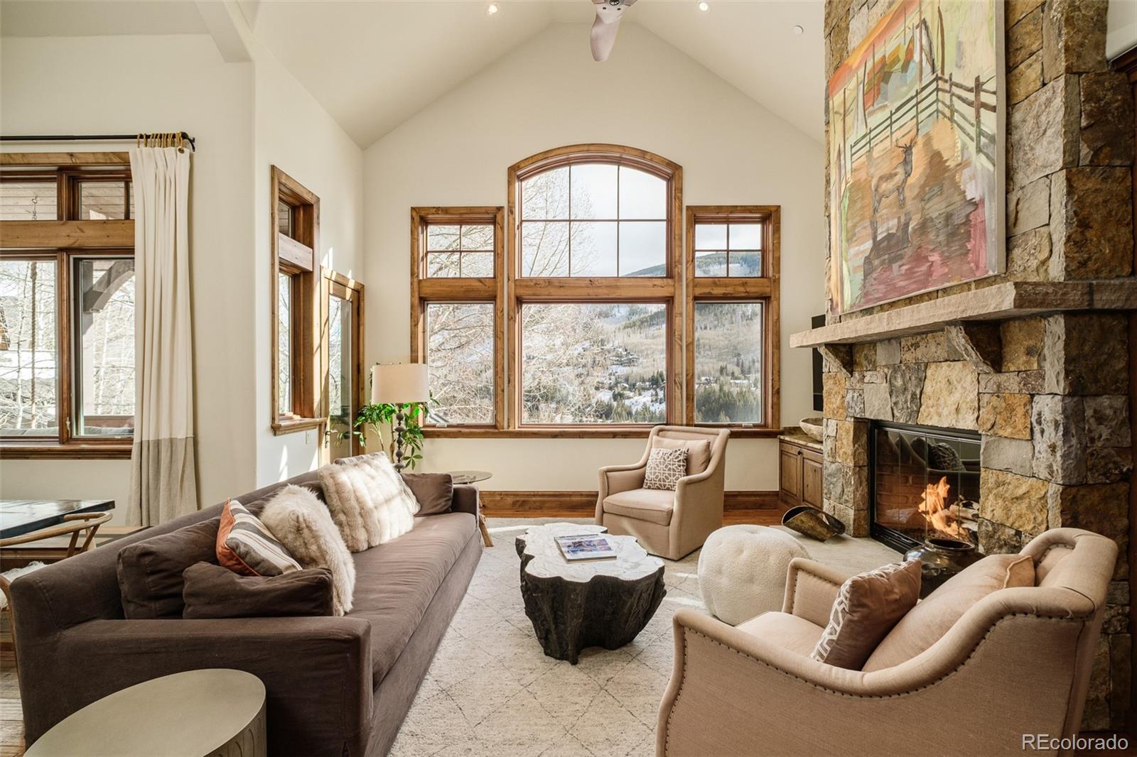 2417 Garmisch Drive, Unit B Vail, CO 81657 - Photo 12 of 43 a living room with furniture fireplace and a large window