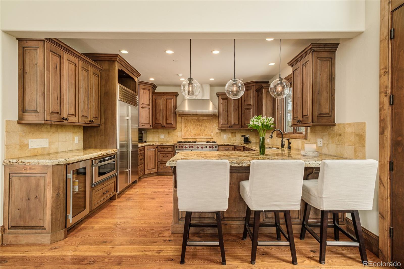 2417 Garmisch Drive, Unit B Vail, CO 81657 - Photo 18 of 43 a large kitchen with a table and chairs