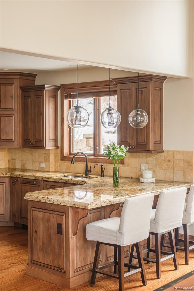 2417 Garmisch Drive, Unit B Vail, CO 81657 - Photo 19 of 43 a kitchen with a cabinets and chairs