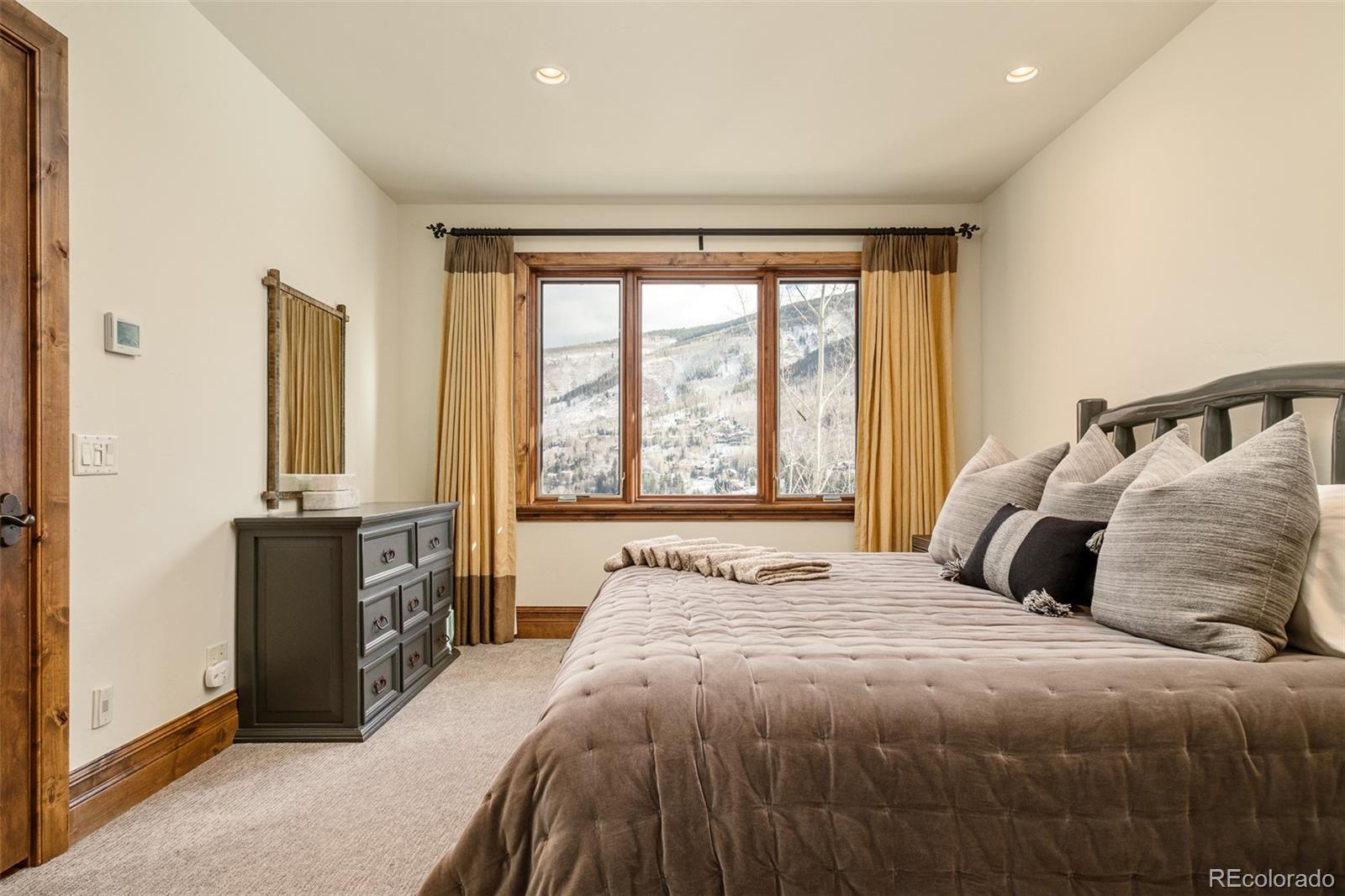 2417 Garmisch Drive, Unit B Vail, CO 81657 - Photo 20 of 43 a bedroom with a large bed and a large window