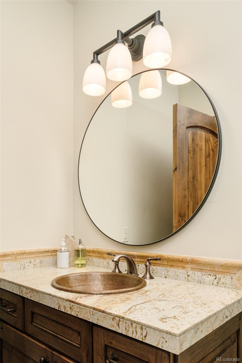 2417 Garmisch Drive, Unit B Vail, CO 81657 - Photo 21 of 43 a bathroom with a granite countertop sink and a mirror
