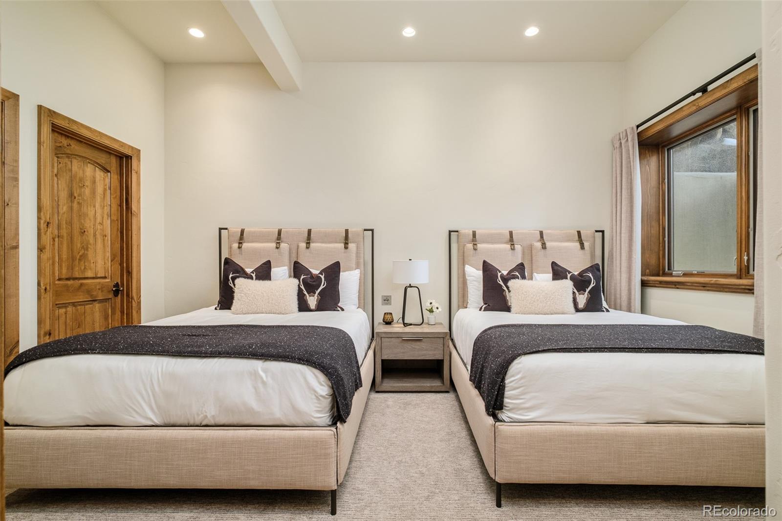 2417 Garmisch Drive, Unit B Vail, CO 81657 - Photo 30 of 43 a bedroom with a bed and wooden floor