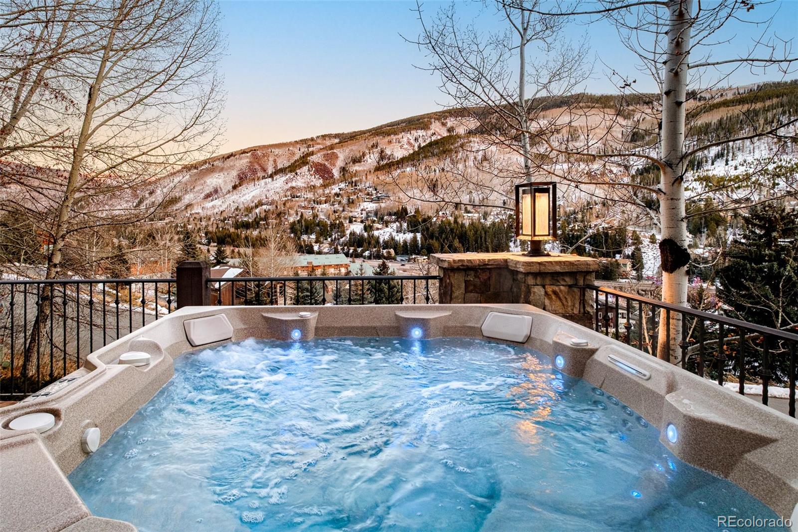 2417 Garmisch Drive, Unit B Vail, CO 81657 - Photo 37 of 43 a view of a swimming pool with a patio and wooden fence