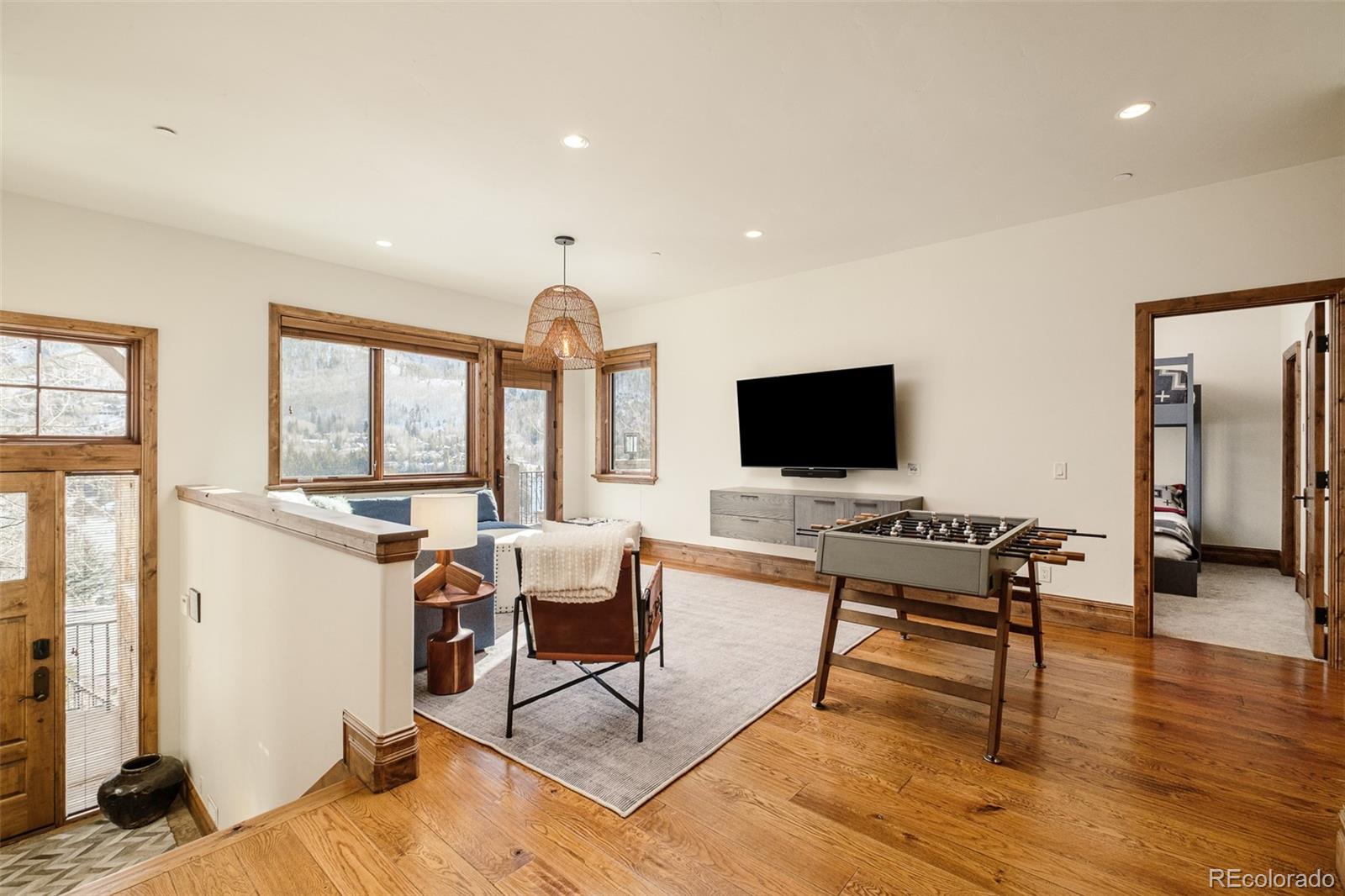 2417 Garmisch Drive, Unit B Vail, CO 81657 - Photo 6 of 43 a living room with furniture and a flat screen tv