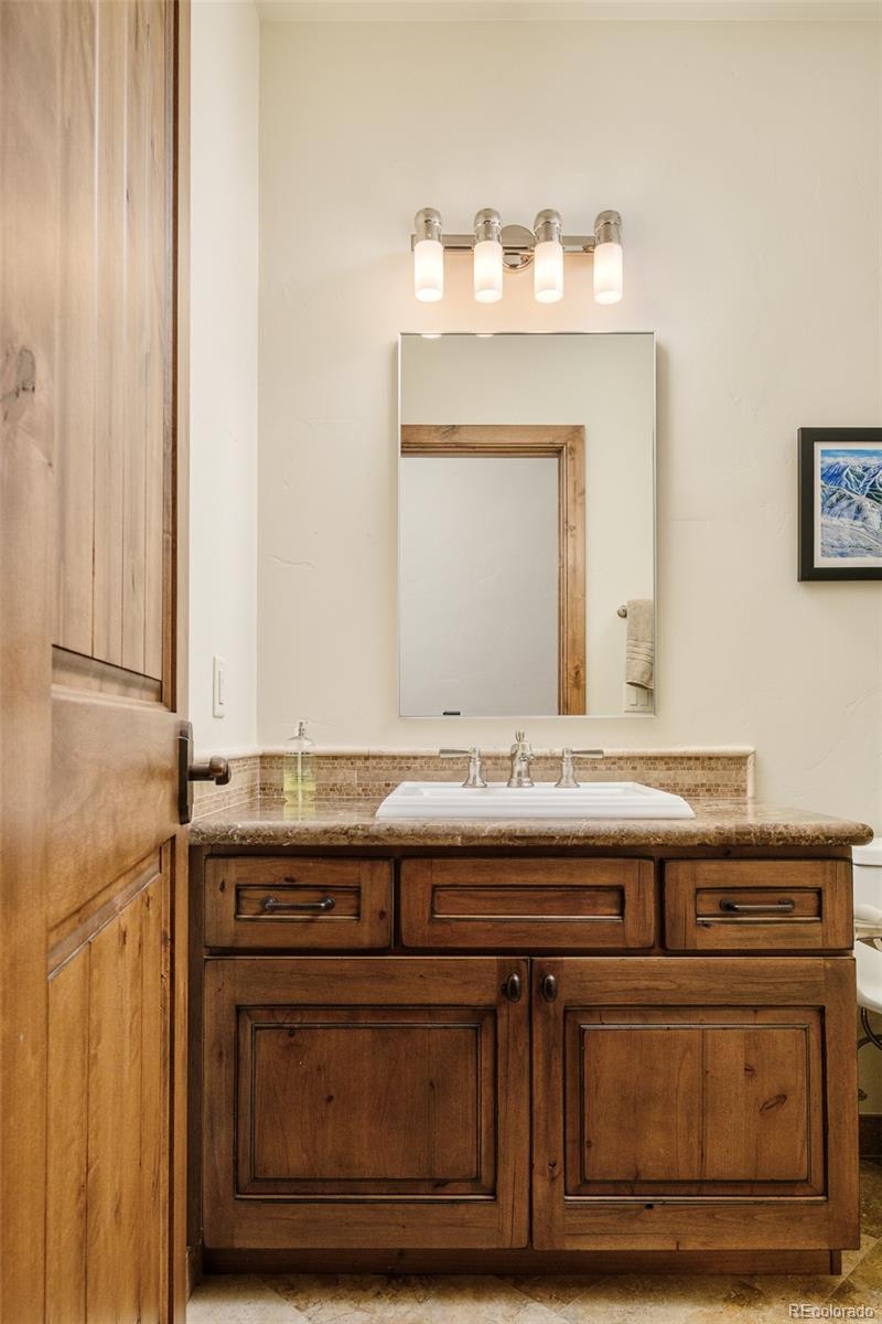 2417 Garmisch Drive, Unit B Vail, CO 81657 - Photo 8 of 43 a view of cabinets with granite countertop a sink and a mirror