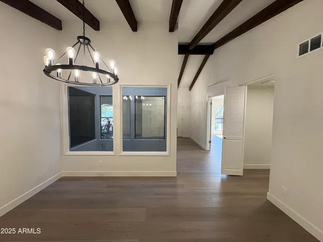 a view of a livingroom with wooden floor and a ceiling fan