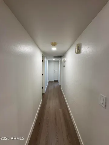 a view of a hallway with wooden floor