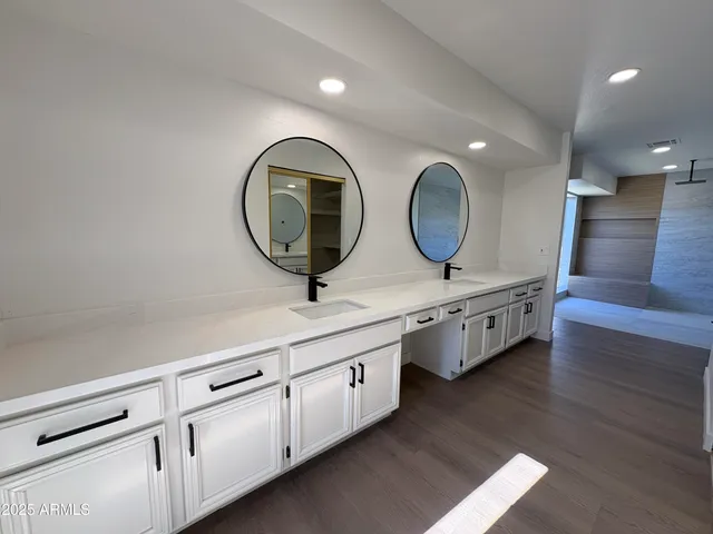 a bathroom with 2 sink and a mirror