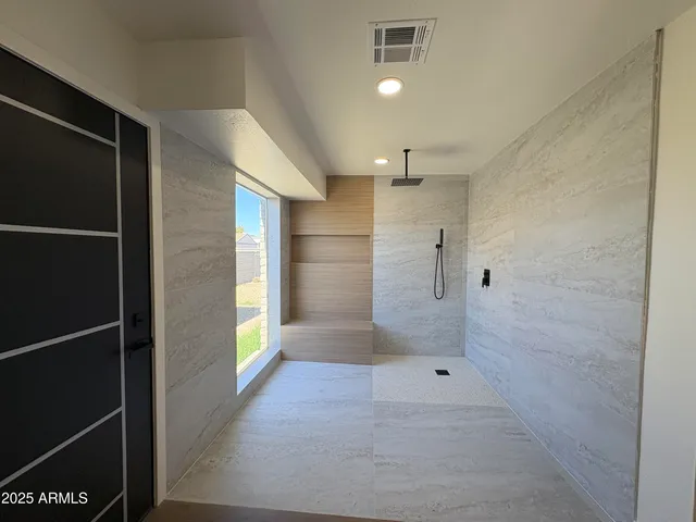 a bathroom with a glass shower door