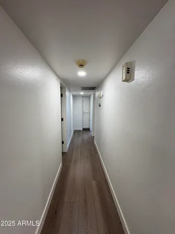 a view of hallway with wooden floor
