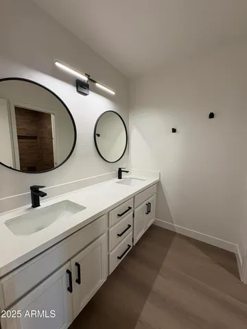 a bathroom with a double vanity sink and a mirror