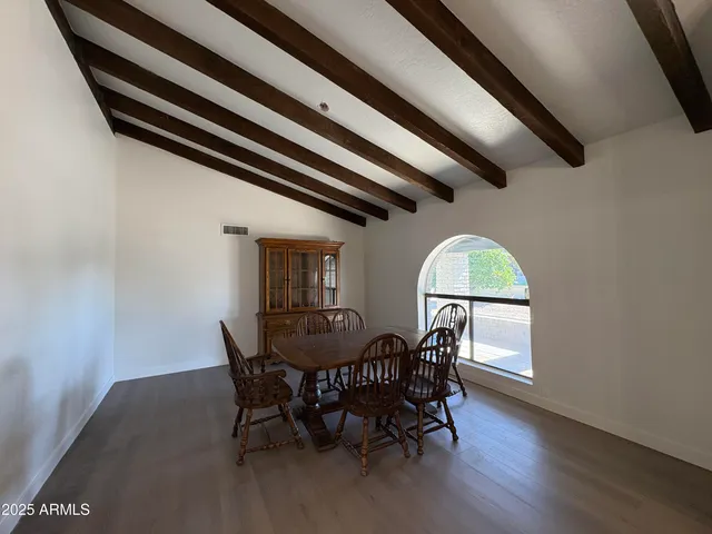 a view of a dining room with furniture and a window