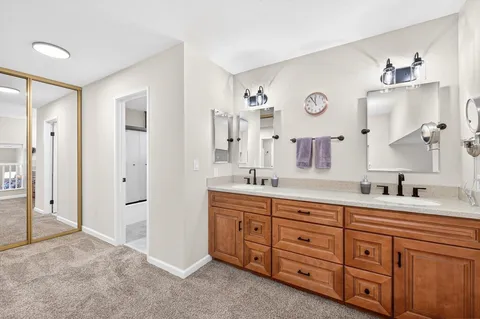 a spacious bathroom with double sink and a mirror