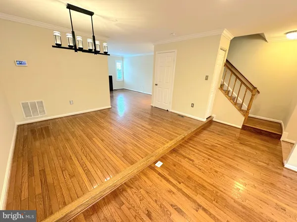 a view of a room with wooden floor