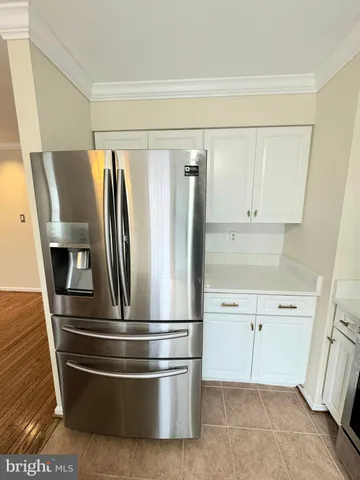a refrigerator freezer sitting inside of a kitchen