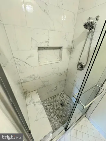 a bathroom with a bathtub and shower