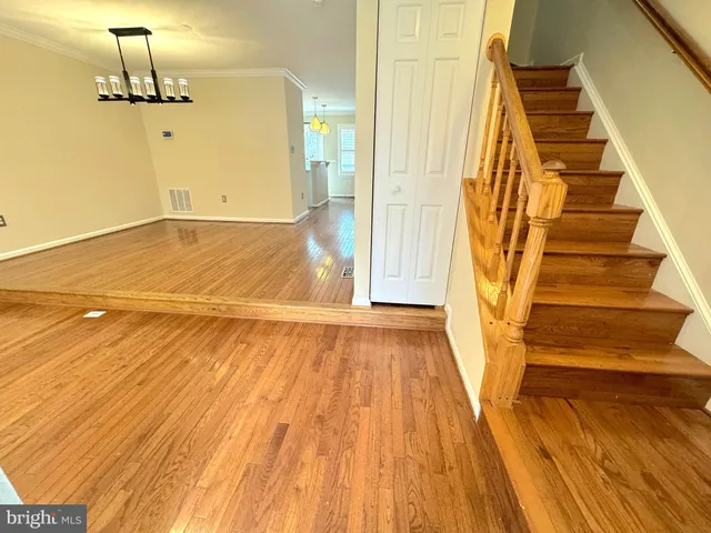 a view of a room with wooden floor and staircase