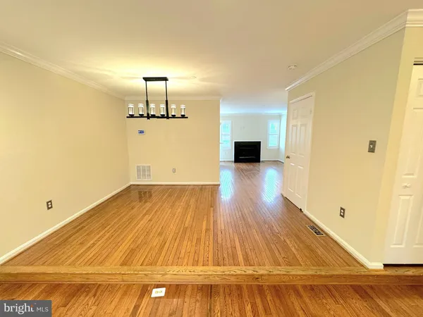 a view of a room with wooden floor
