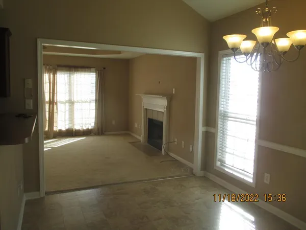 a view of empty room with window and fireplace