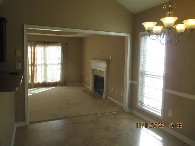 a view of empty room with window and fireplace