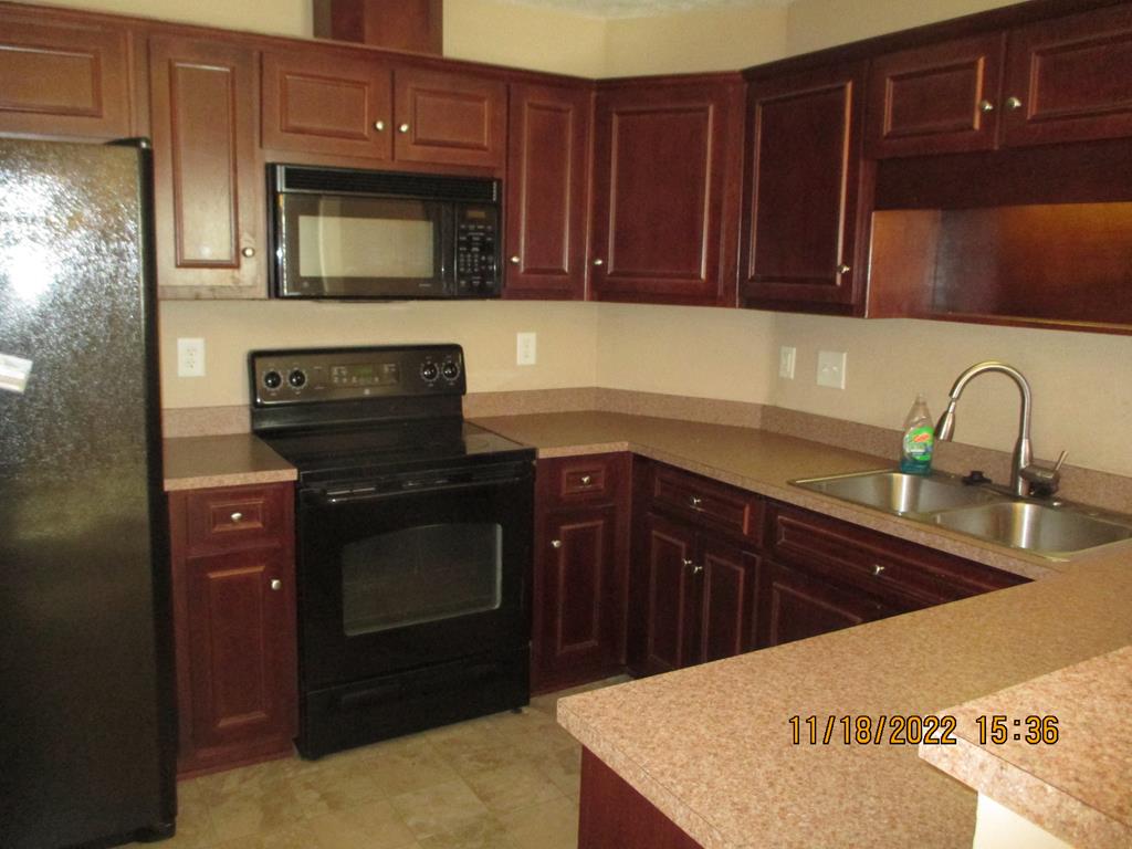 8094 Santee Court Columbus, GA 31909 - Photo 6 of 7 a kitchen with granite countertop a sink stainless steel appliances and cabinets