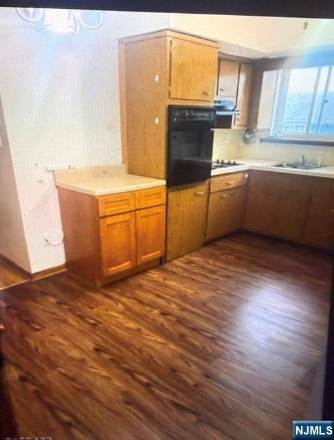 490 Union Avenue Rutherford, NJ 07070 - Photo 8 of 11 a kitchen with stainless steel appliances wooden floors and a sink