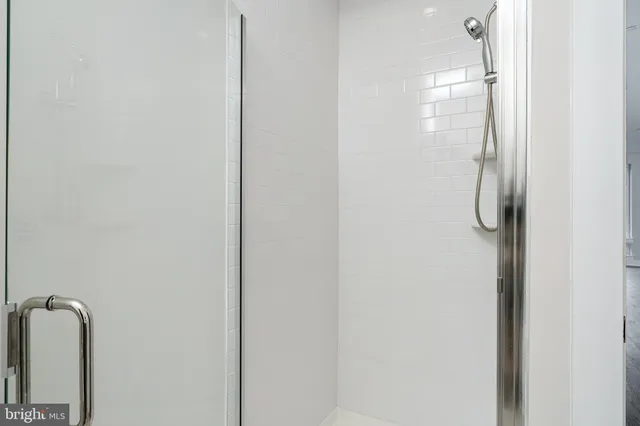 a bathroom with a glass shower door