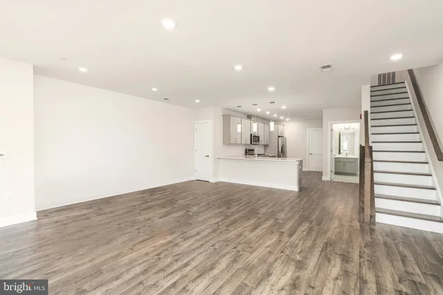 a view of kitchen and hall with wooden floor