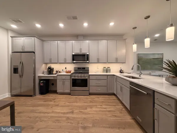 a kitchen with stainless steel appliances granite countertop a refrigerator sink and cabinets