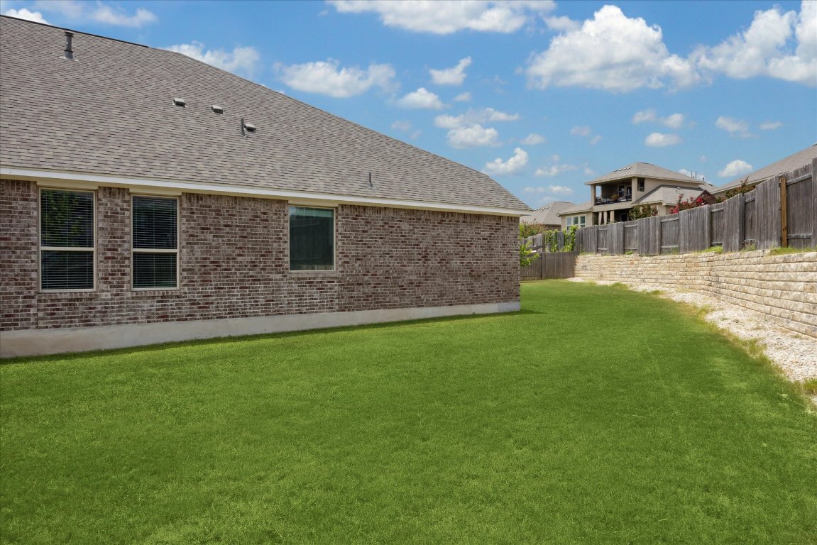 744 Founders Ridge Dripping Springs, TX 78620 - Photo 28 of 32 a backyard of a house with lots of green space
