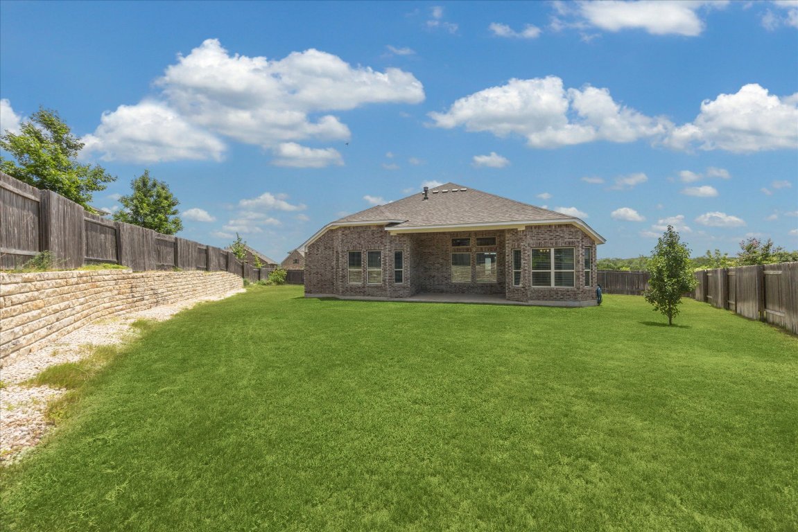 744 Founders Ridge Dripping Springs, TX 78620 - Photo 29 of 32 a view of a house with a backyard