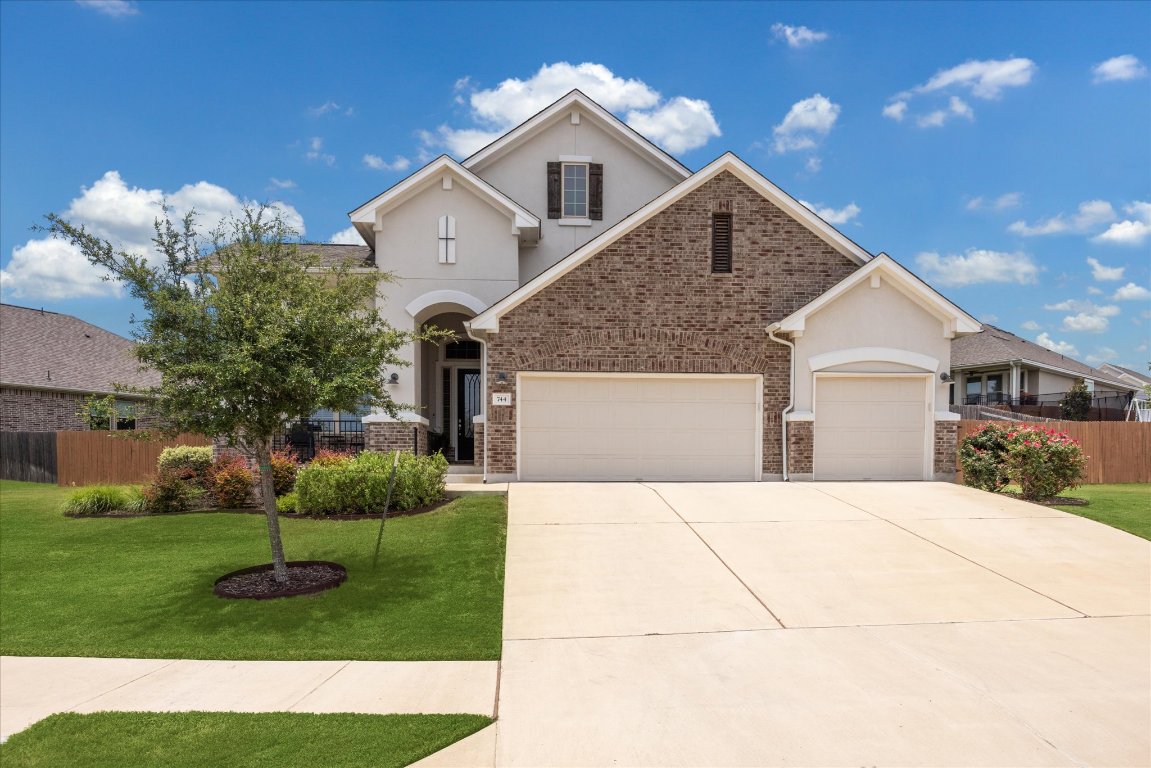744 Founders Ridge Dripping Springs, TX 78620 - Photo 3 of 32 a front view of a house with a yard