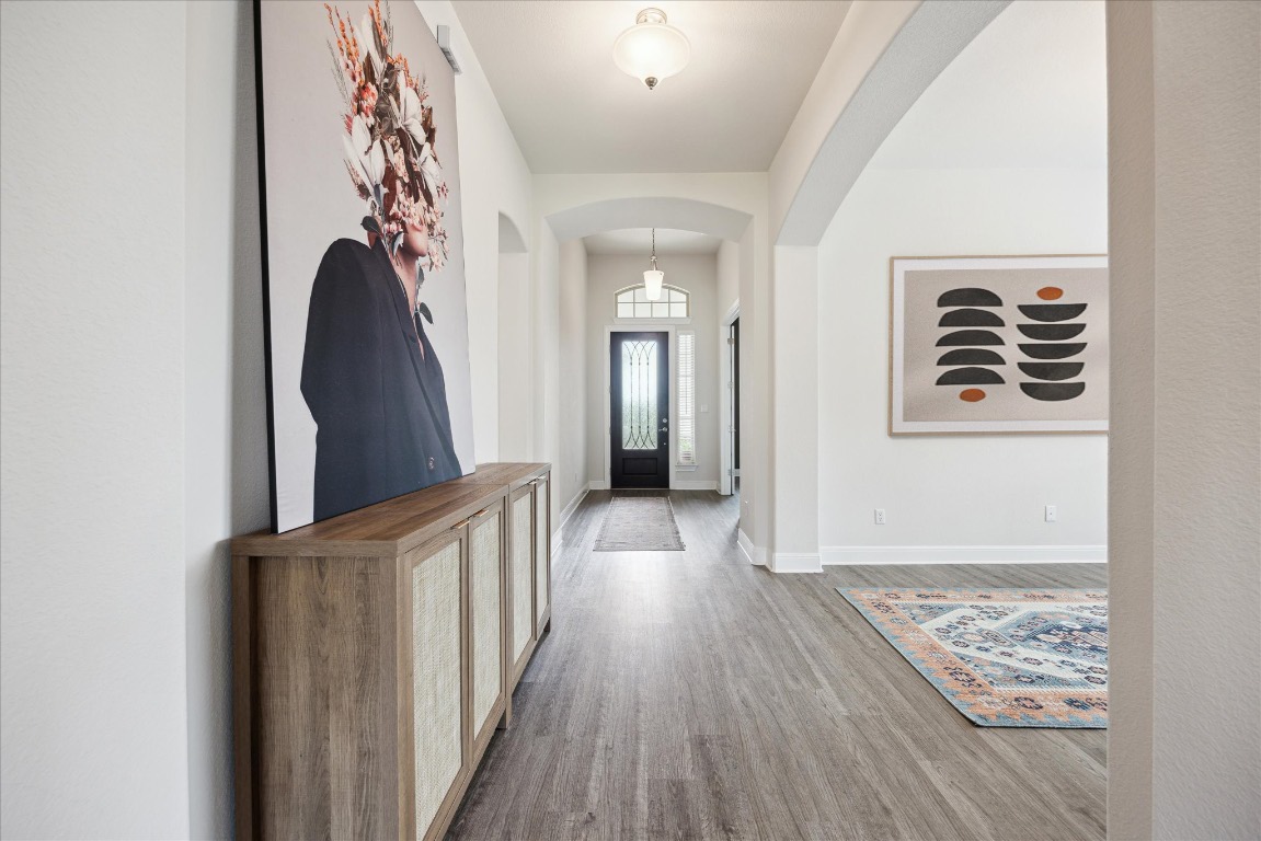 744 Founders Ridge Dripping Springs, TX 78620 - Photo 5 of 32 a view of a hallway with wooden floor and staircase