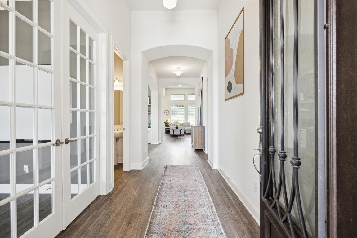 744 Founders Ridge Dripping Springs, TX 78620 - Photo 6 of 32 a view of a hallway with wooden floor and staircase