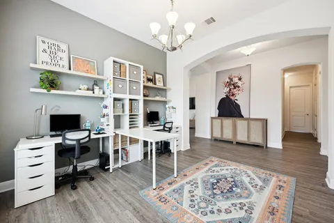a view of a livingroom with workspace and a window