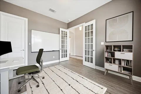 a view of a workspace with furniture and a window