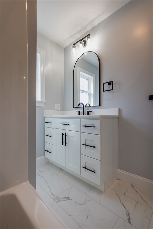 153 Ray Street Fall River, MA 02720 - Photo 20 of 29 a bathroom with a double vanity sink and a mirror