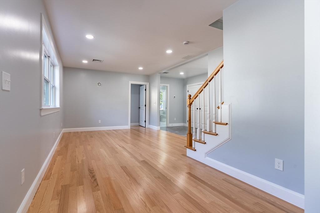 153 Ray Street Fall River, MA 02720 - Photo 7 of 29 a view of a hallway with wooden floor and staircase