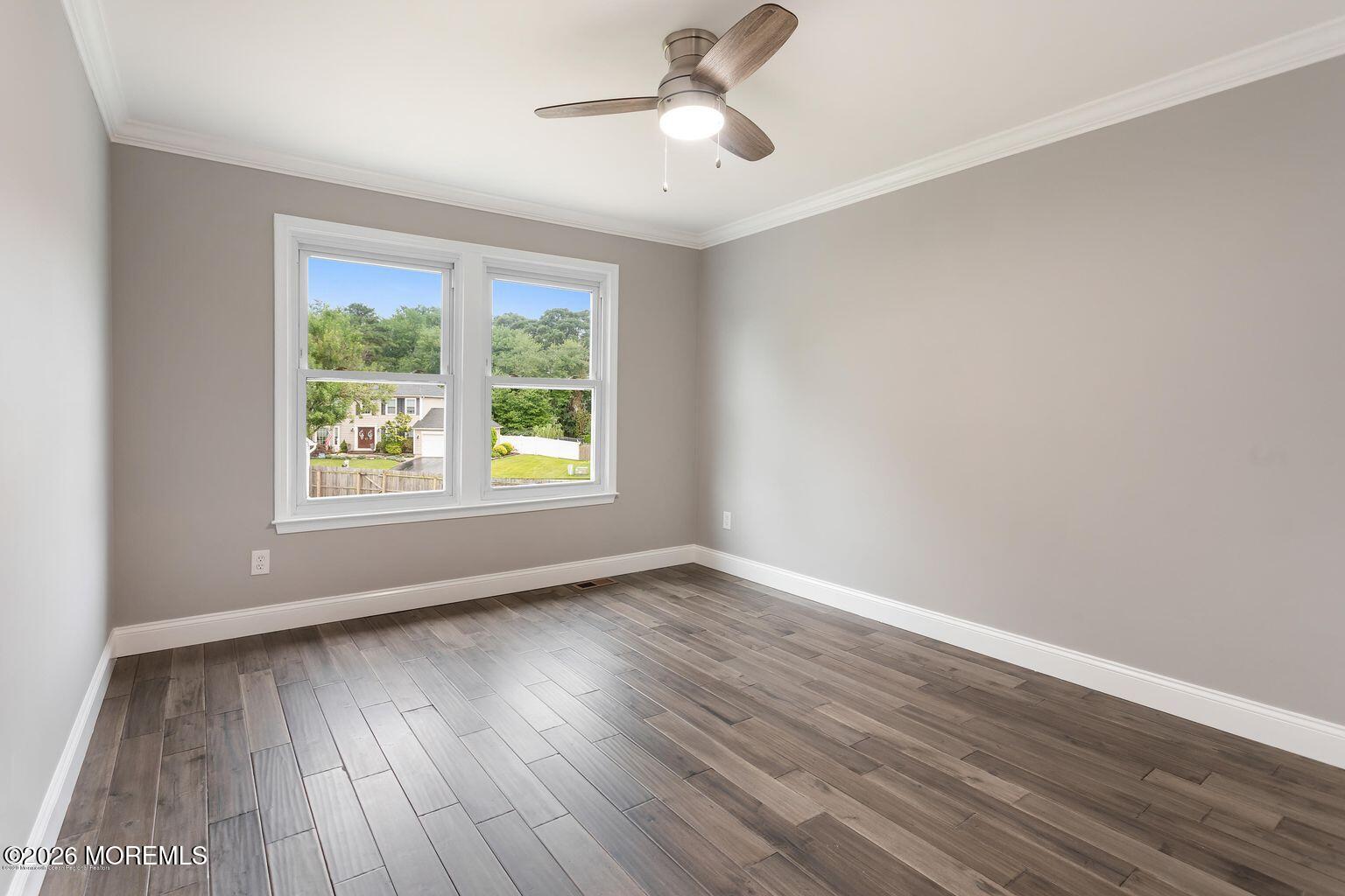 23 Sami Drive Howell, NJ 07731 - Photo 11 of 26 a view of an empty room with wooden floor and a window