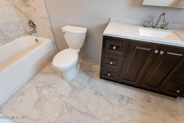 a bathroom with a sink a toilet and bathtub